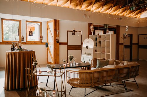 Sofas and low tables in Diamentowa, fairy lights along the timber trusses