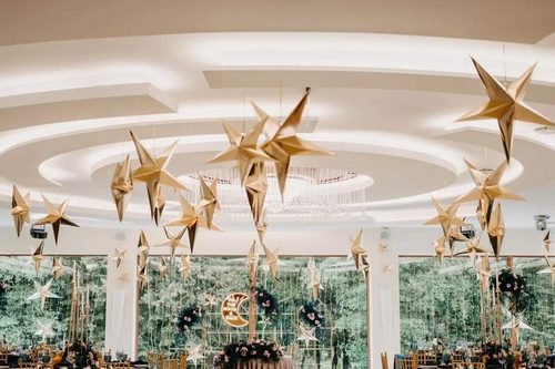 Gold stars hung under the domed ceiling of the Tarasowa hall