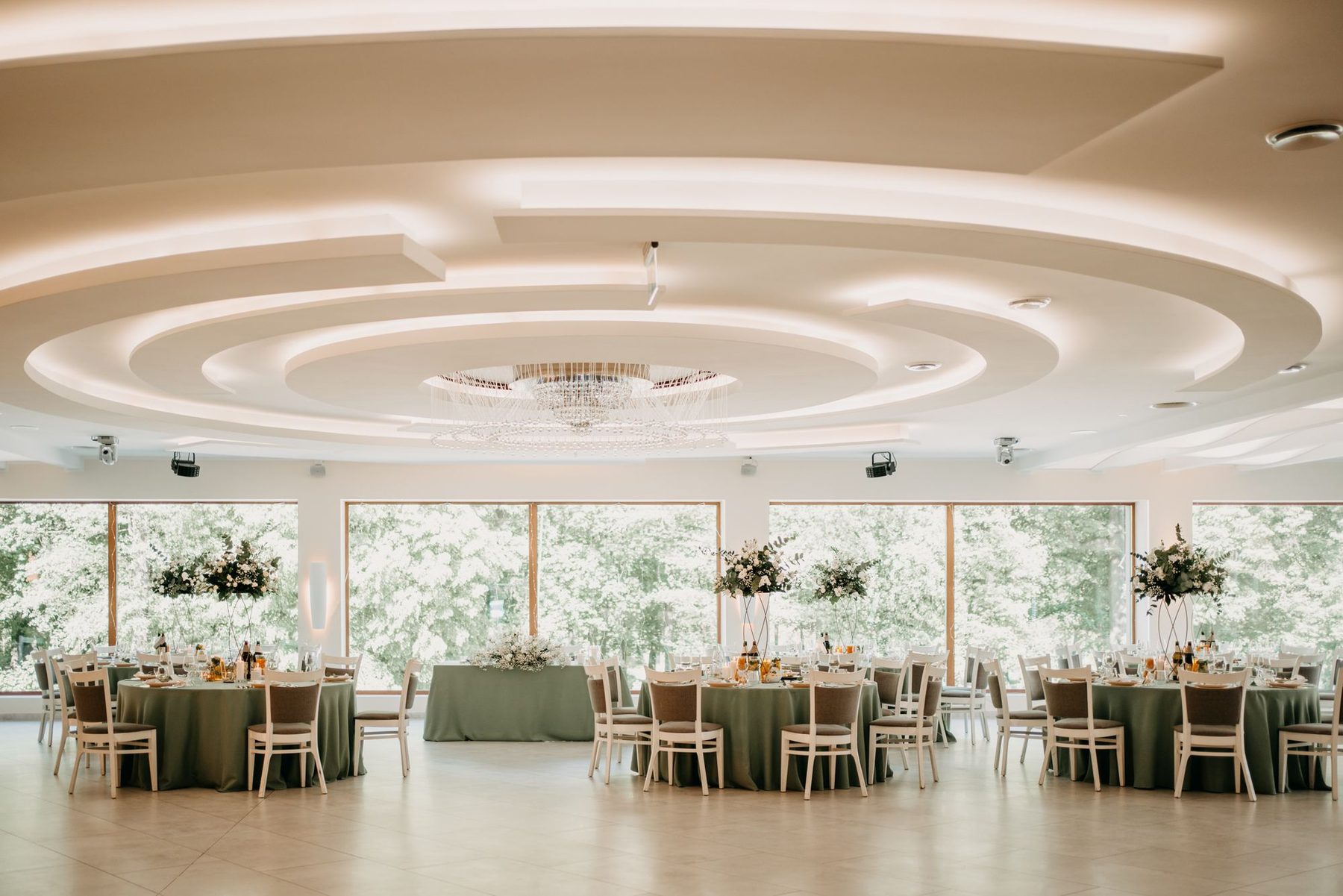 Tarasowa: the lit domed ceiling, a crystal chandelier and a glazed wall onto the park